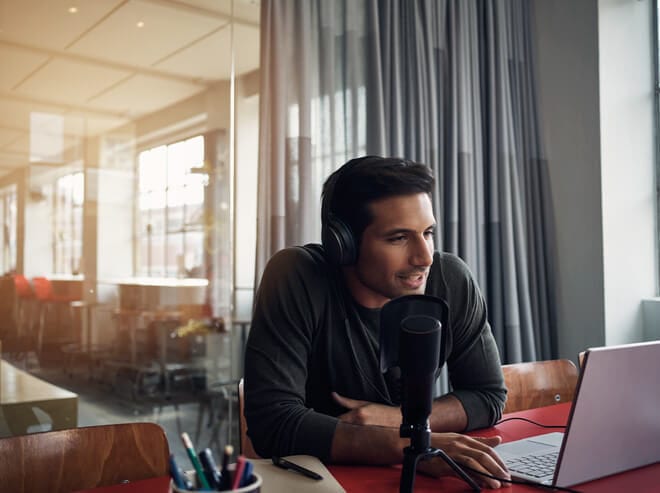 Podcaster speaking into microphone